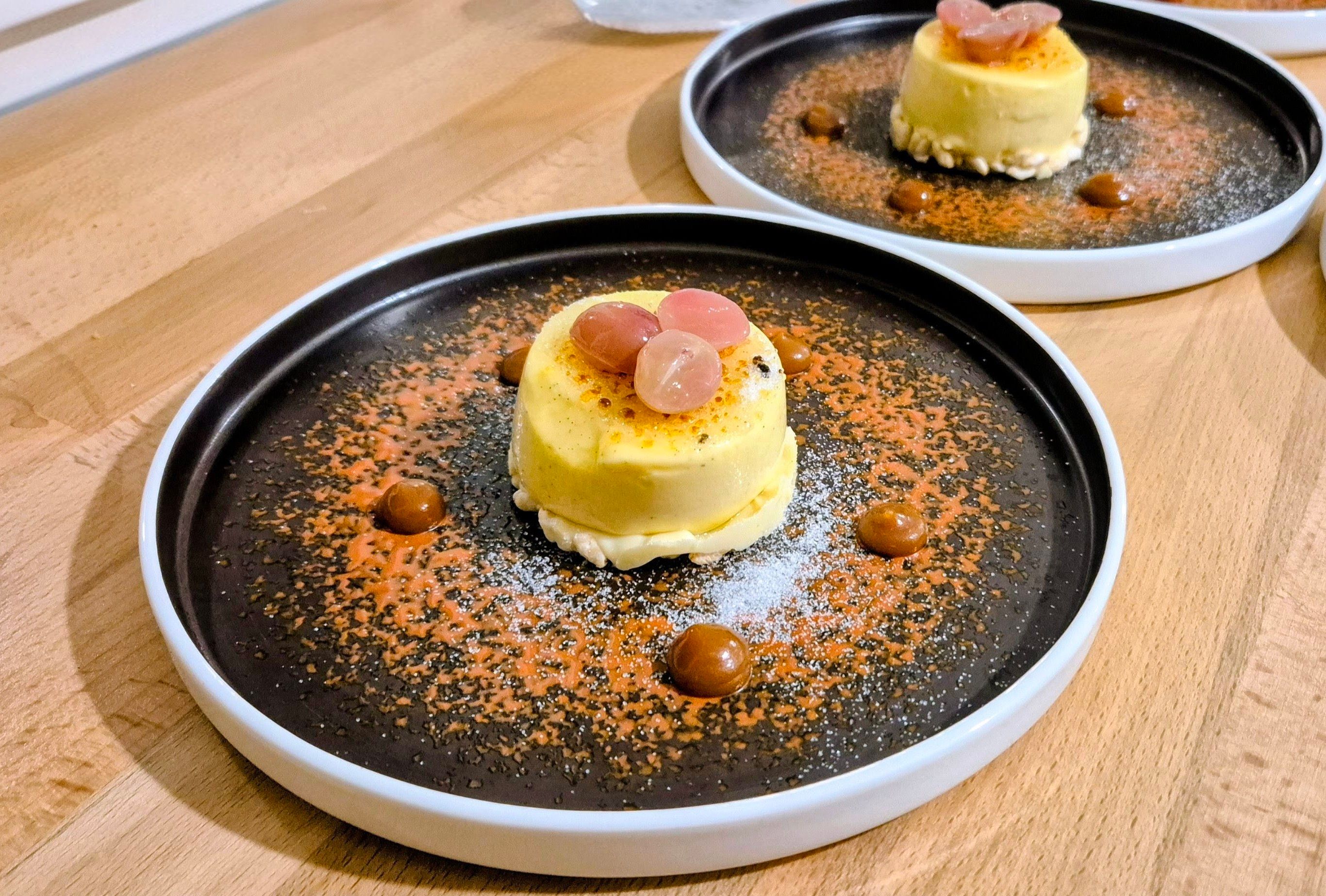 Dessert crémeux dressé sur une assiette noire